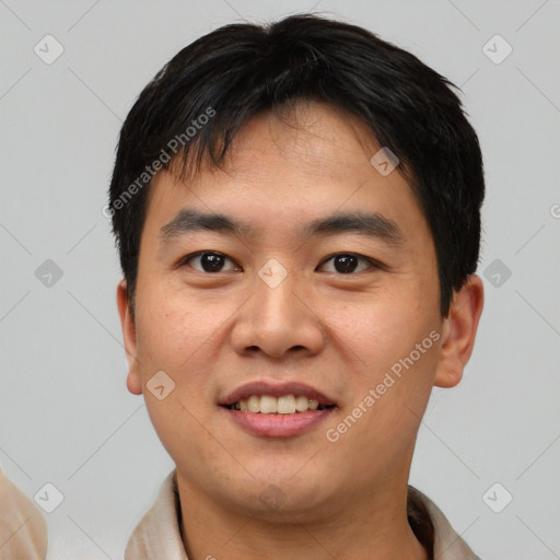 Joyful asian young-adult male with short  black hair and brown eyes