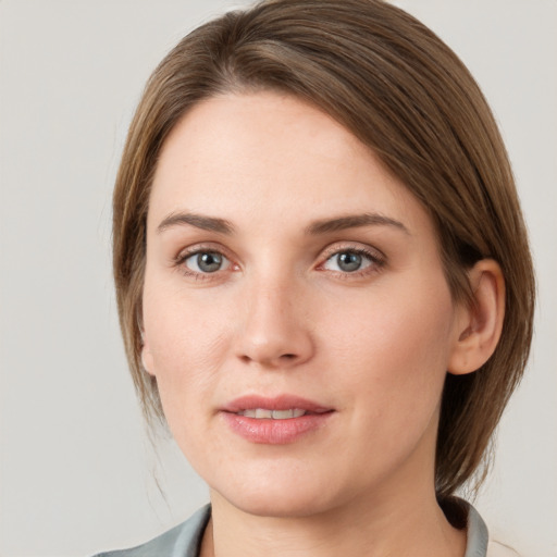 Joyful white young-adult female with medium  brown hair and grey eyes