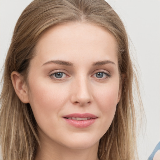 Joyful white young-adult female with long  brown hair and blue eyes