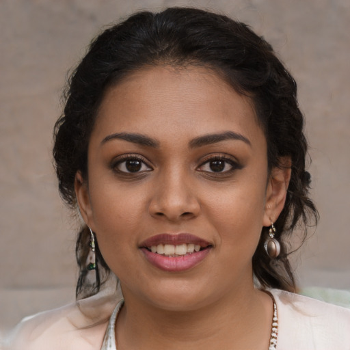 Joyful latino young-adult female with medium  brown hair and brown eyes