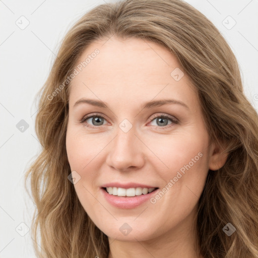 Joyful white young-adult female with long  brown hair and green eyes