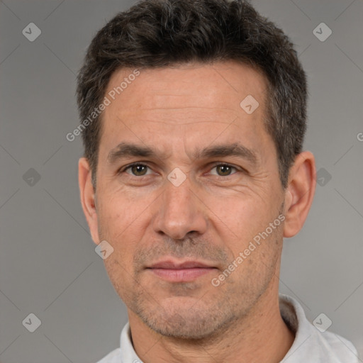 Joyful white adult male with short  brown hair and brown eyes