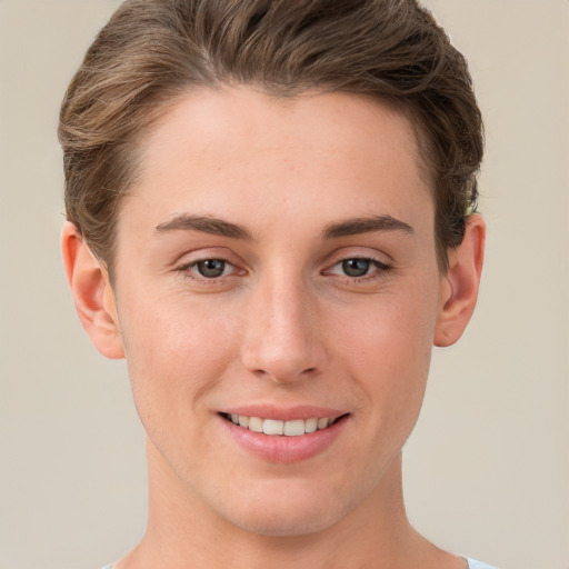 Joyful white young-adult female with short  brown hair and grey eyes