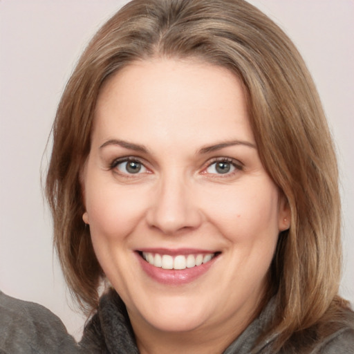 Joyful white adult female with medium  brown hair and brown eyes