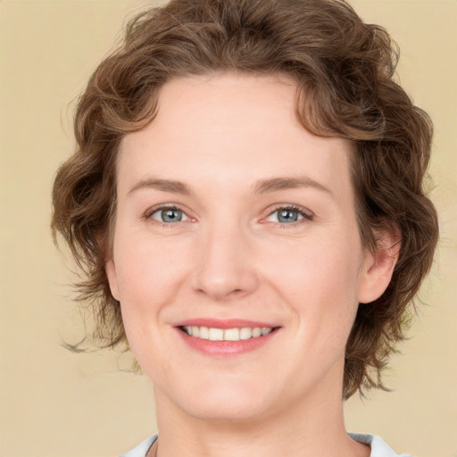 Joyful white young-adult female with medium  brown hair and green eyes