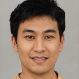 Joyful asian young-adult male with short  black hair and brown eyes