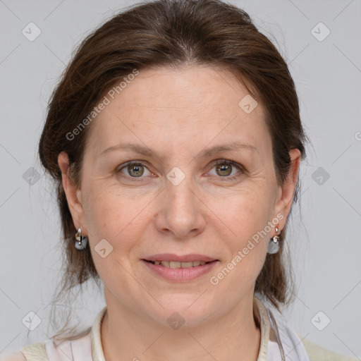 Joyful white adult female with medium  brown hair and grey eyes