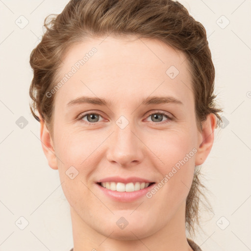 Joyful white young-adult female with short  brown hair and grey eyes