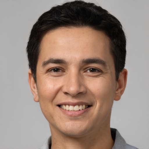 Joyful white young-adult male with short  black hair and brown eyes