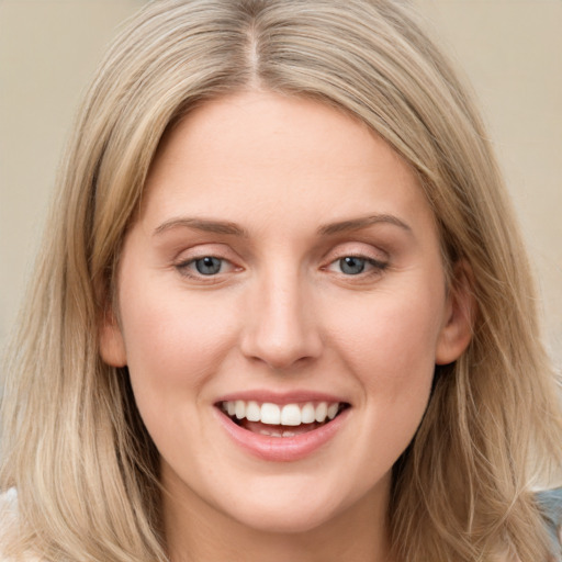 Joyful white young-adult female with long  brown hair and blue eyes