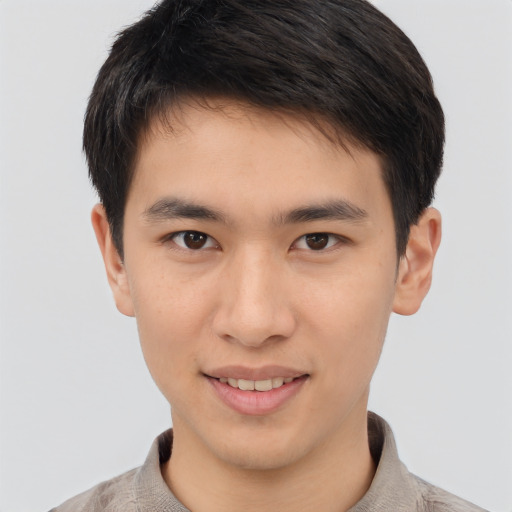 Joyful asian young-adult male with short  brown hair and brown eyes
