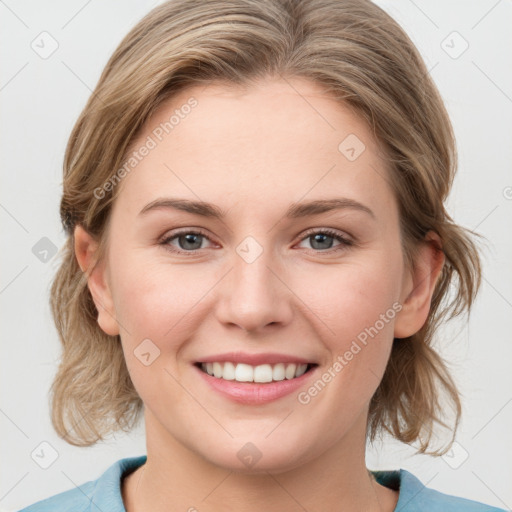 Joyful white young-adult female with medium  brown hair and blue eyes