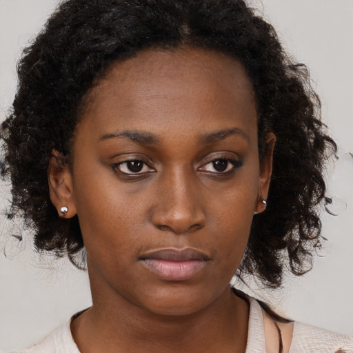 Neutral black young-adult female with medium  brown hair and brown eyes