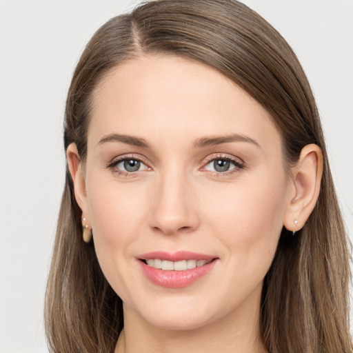 Joyful white young-adult female with long  brown hair and grey eyes