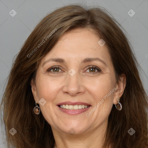 Joyful white adult female with long  brown hair and grey eyes