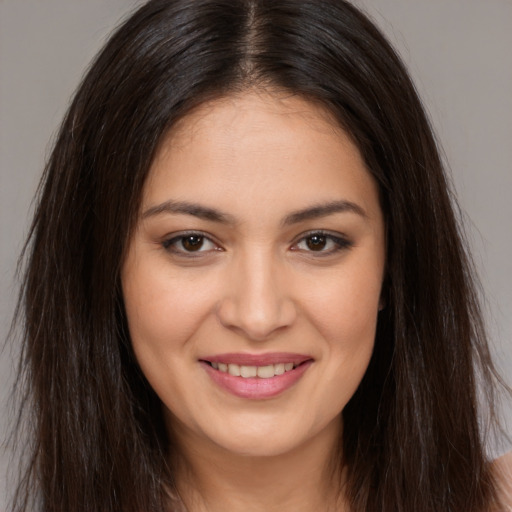 Joyful white young-adult female with long  brown hair and brown eyes
