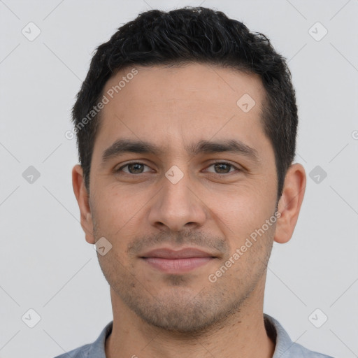 Joyful white young-adult male with short  black hair and brown eyes