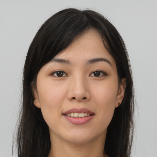 Joyful asian young-adult female with long  brown hair and brown eyes