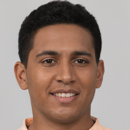 Joyful latino young-adult male with short  brown hair and brown eyes