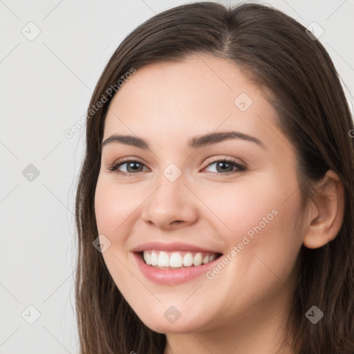 Joyful white young-adult female with long  brown hair and brown eyes