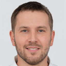 Joyful white young-adult male with short  brown hair and brown eyes