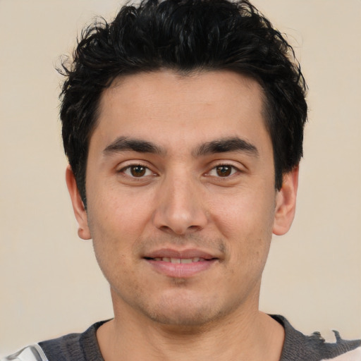 Joyful white young-adult male with short  black hair and brown eyes