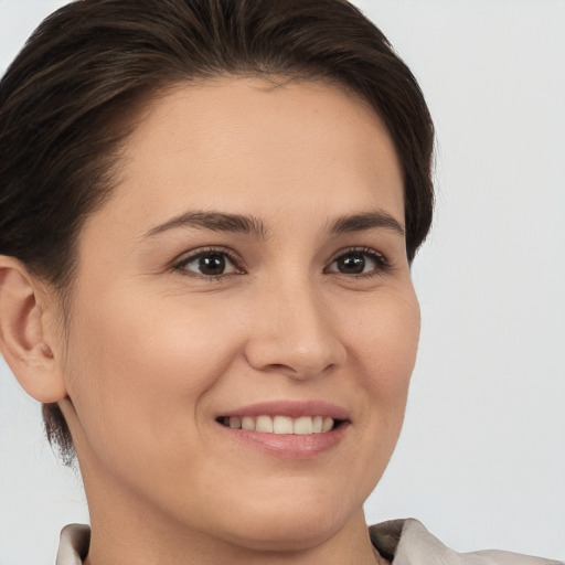 Joyful white young-adult female with short  brown hair and brown eyes