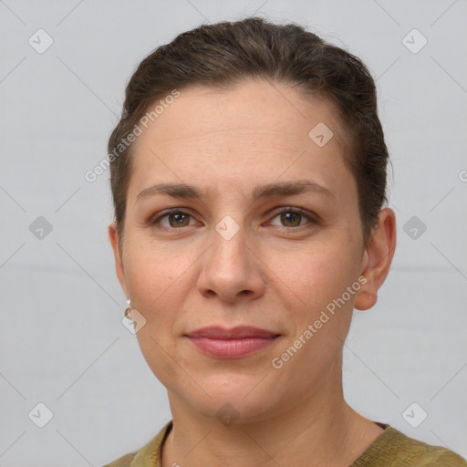 Joyful white adult female with short  brown hair and grey eyes