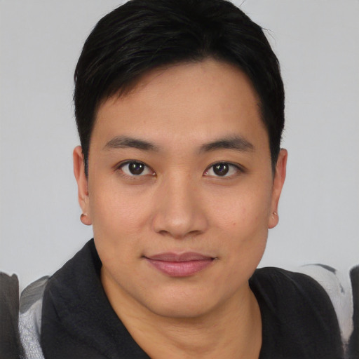 Joyful asian young-adult male with short  black hair and brown eyes
