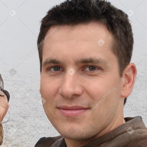 Joyful white young-adult male with short  brown hair and brown eyes