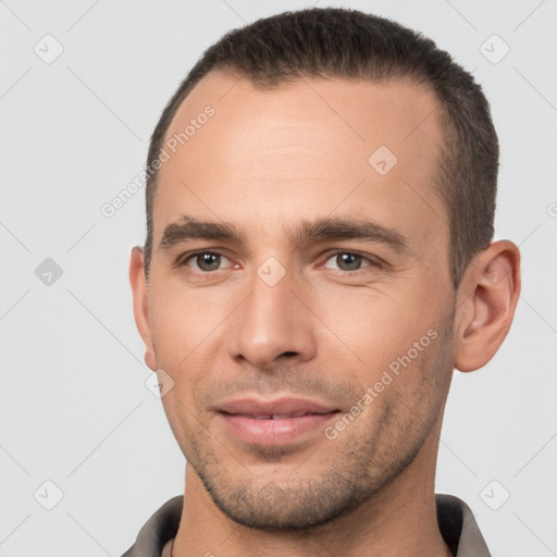 Joyful white young-adult male with short  brown hair and brown eyes