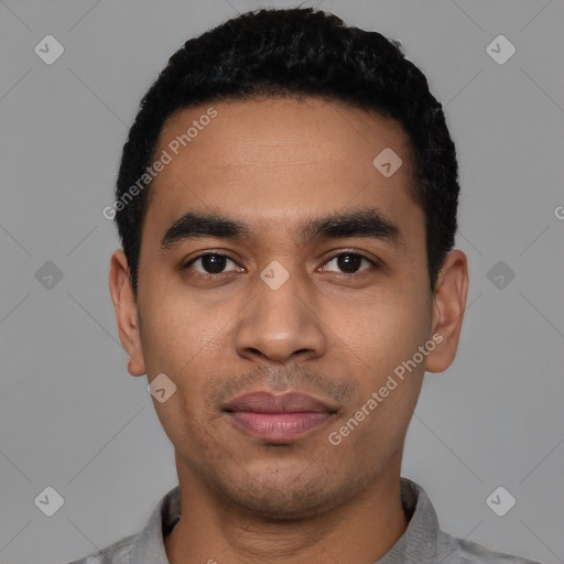 Joyful latino young-adult male with short  black hair and brown eyes