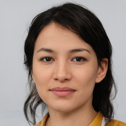 Joyful white young-adult female with medium  black hair and brown eyes