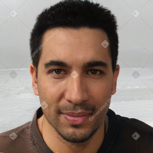 Joyful latino young-adult male with short  black hair and brown eyes