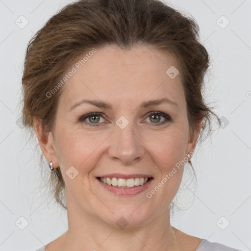 Joyful white adult female with medium  brown hair and grey eyes