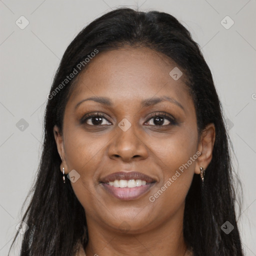 Joyful black young-adult female with long  brown hair and brown eyes