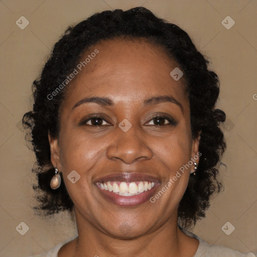 Joyful black adult female with long  brown hair and brown eyes