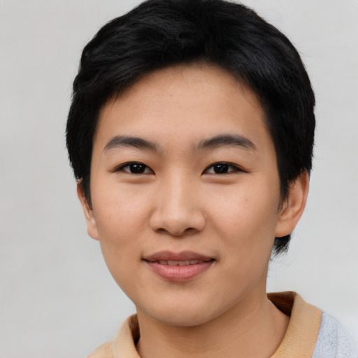 Joyful asian young-adult female with short  black hair and brown eyes