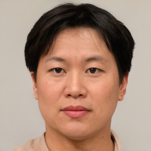 Joyful asian adult female with short  brown hair and brown eyes