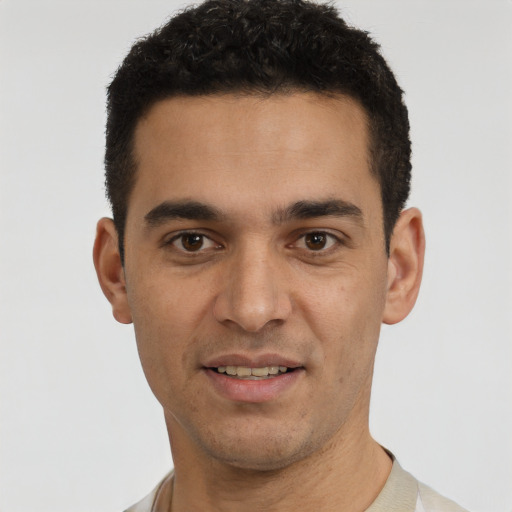 Joyful white young-adult male with short  black hair and brown eyes