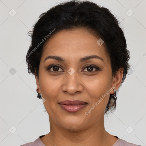 Joyful latino adult female with medium  brown hair and brown eyes