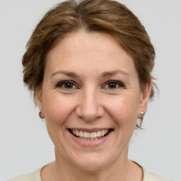 Joyful white adult female with medium  brown hair and grey eyes