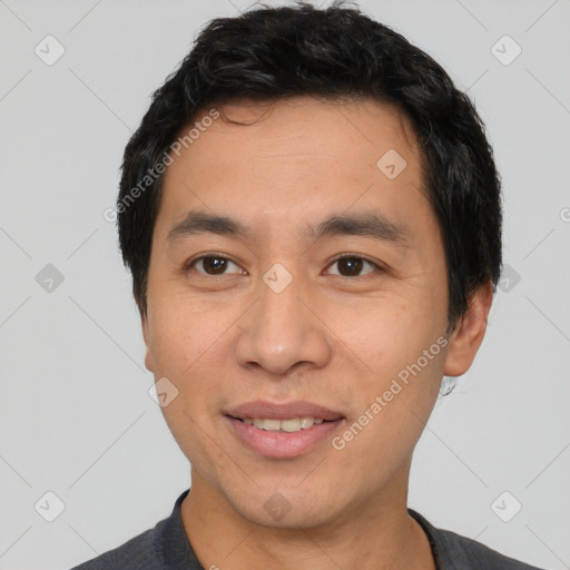 Joyful asian young-adult male with short  black hair and brown eyes