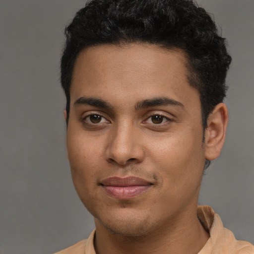 Joyful latino young-adult male with short  brown hair and brown eyes