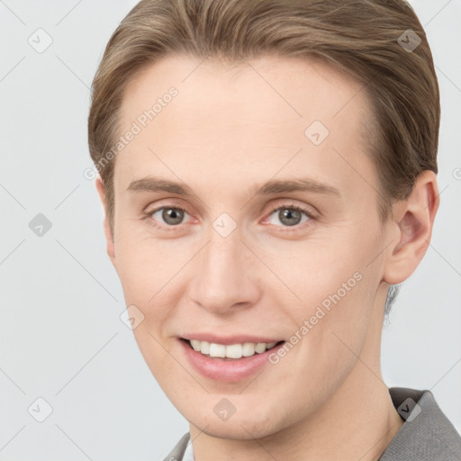 Joyful white young-adult female with short  brown hair and grey eyes