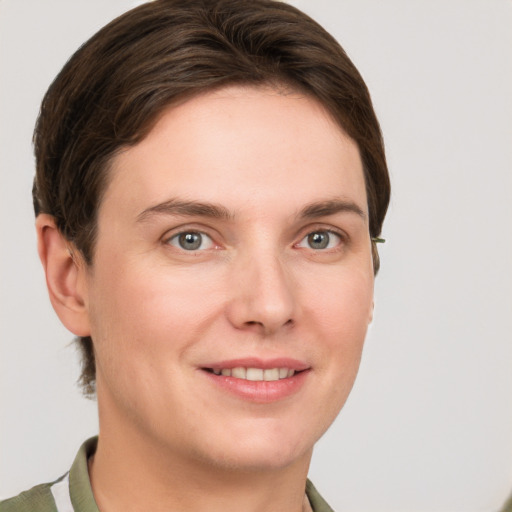 Joyful white young-adult female with short  brown hair and grey eyes