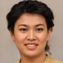 Joyful asian young-adult female with medium  brown hair and brown eyes