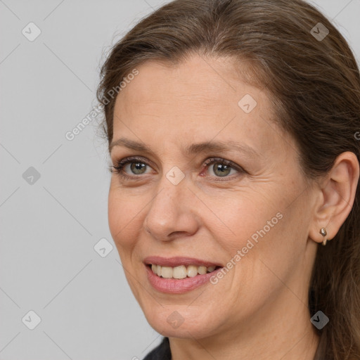 Joyful white adult female with long  brown hair and brown eyes