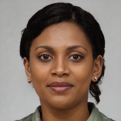 Joyful black young-adult female with medium  black hair and brown eyes