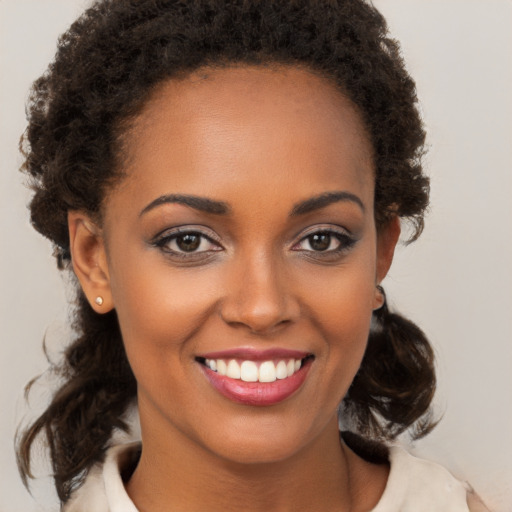 Joyful black young-adult female with medium  brown hair and brown eyes